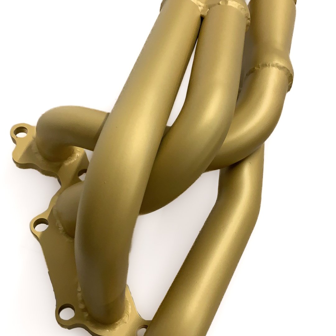 Headers treated in a golden cerakote paint.